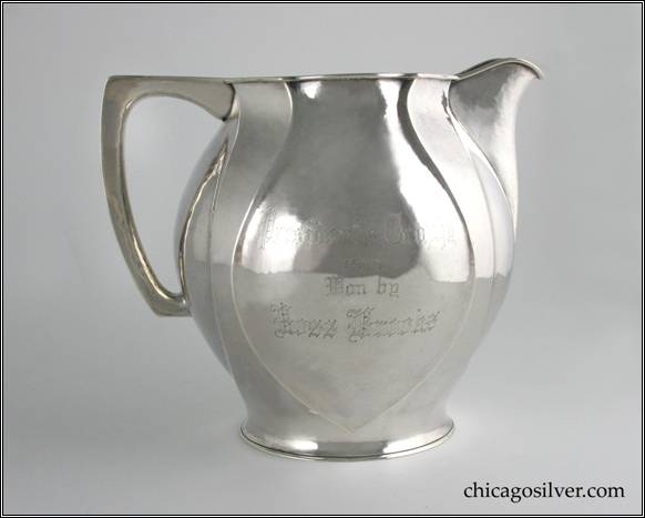 Kalo pitcher, water, bulbous form with four paneled sides and alternating, recessed, inverted spade shapes with flat top hollow handle.  Side is engraved "Presidents Trophy 1913 Won by Ross Brooks."  Underside is engraved "Presented By Albert J. Buckheit."  Nicely hammered surfaces.  7-1/4" H and 8-1/2" W.  STERLING / HAND WROUGHT / AT / THE KALO SHOPS / CHICAGO / AND / NEW YORK / 10429