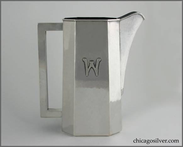 Kalo water pitcher, beautiful paneled form with flat bottom and square section hollow handle, hammered surfaces, rising spout, and slightly tapered base, applied W mono "An exceptional, early example." 9-3/16" H to top of spout and 8-1/4" W.  STERLING / HAND BEATEN / AT / KALO SHOPS / PARK RIDGE / ILLS. / 8238