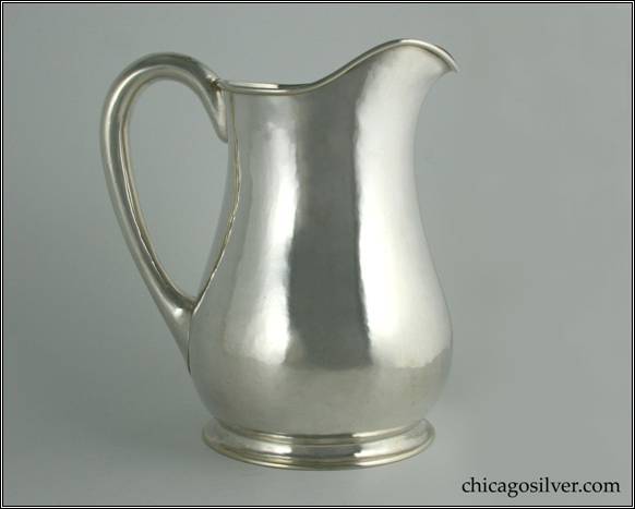 Kalo pitcher, water, hammered surfaces with low ring foot and hollow handle, raised spout.  10-1/2" H and 7-1/2" W.  STERLING / HANDWROUGHT / AT / THE KALO SHOPS / CHICAGO / AND / NEW YORK / E371