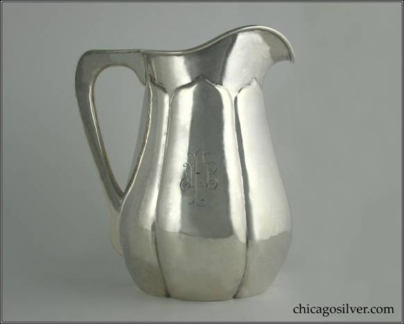 Kalo pitcher, water, with wide melon ribs each coming to a point beneath the rim, flat bottom, flat edge harp-shaped hollow handle, applied wire on rim, engraved "IFB" mono on side.  9" H and 7-1/2" W.  STERLING / HAND WROUGHT / AT / THE KALO SHOPS / CHICAGO / AND / NEW YORK / 7533