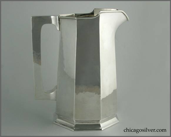 Kalo pitcher, water, gently tapering paneled form with flat top and bottom square section hollow handle, rising spout, on small foot, with applied wire to rim and engraved "F" mono on side.  8" W and 9-1/2" H.  STERLING / HANDWROUGHT / AT / THE KALO SHOP / G579