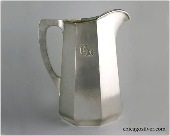 Kalo pitcher, water, tall tapered paneled form on low self-foot with applied "Mac" mono, arching spout, heavy wire applied to rim, and harp-shaped square-section hollow handle with flat top.  Nicely hammered surfaces.  Heavy.  From the estate of Allison & Elizabeth Macdonald of E. Topsham, VT.  10" H and 8-1/4" W.  STERLING / HAND WROUGHT / AT / THE KALO SHOP / G574LL