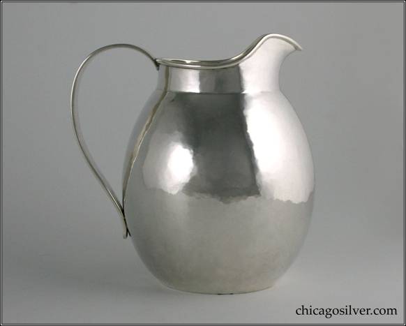 Kalo milk pitcher / jug, small, egg shaped form on flat bottom with necked in top, slightly flared spout and looping strap handle.  Nicely hammered.  5-1/2" W and 6-1/8" H.  STERLING / HAND BEATEN / AT / KALO SHOPS / PARK RIDGE / ILLS. / 9303