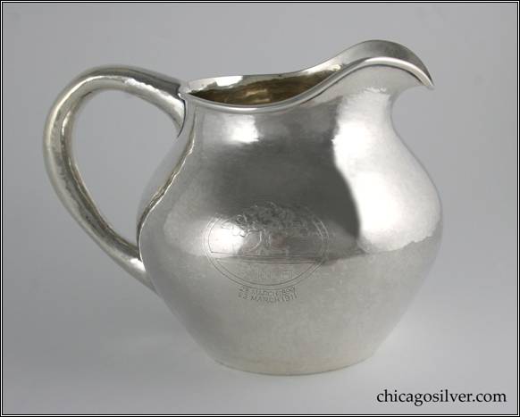 Kalo pitcher, low, squat ovoid form, body tapering at rim with a gracefully arching spout and looping round section hollow handle.   Applied wire to rim.  With engraved tree in circle and "BMH / 23 March 1899 / 23 March 1911" 8-3/4" W and 6-1/2" H.  STERLING / HAND BEATEN / AT / KALO SHOPS / PARK RIDGE / ILLS. / 7978