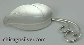 Potter Mellen spoon, in the form of a curving leaf with chased stylized details, and two curving heavy wire stems each with silver bead finial