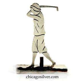 Potter Bentley placecard holder in the form of a female golfer swinging a golf club, handwrought in sterling silver with a split rectangular base that has an upright prong for holding a placecard, and pierced and chased detail