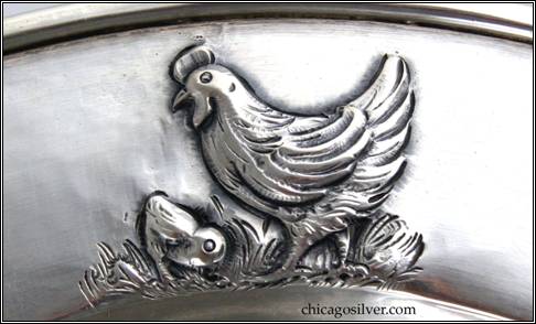 Kalo plate, child's, round, with slightly raised border with repousse hen and chick -- detail