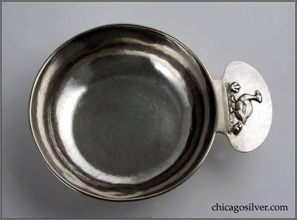 Kalo porringer, flaring bowl with applied wire on rim and tab-like handle which has a chased and repousse design featuring a mother duck with two smaller ducklings.  Hammered surface.  Engraved DOROTHY on side.