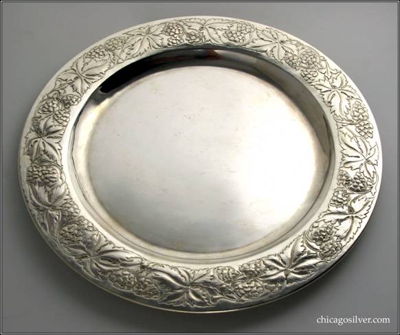 Kalo tray, one of two, round with decorated borders.  This with chased raspberry and vine design