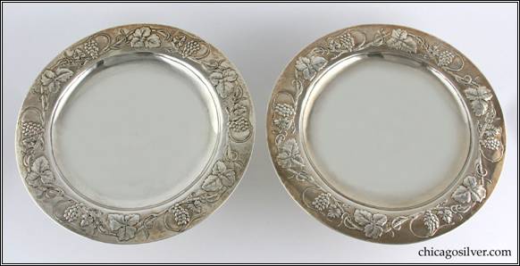 Kalo compotes, low, matching pair (2), broad, round pedestal base supporting shallow dish with raised flange which has a fine chased and repousse grapevine and leaf design