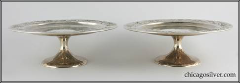 Kalo compotes, low, matching pair (2), broad, round pedestal base supporting shallow dish with raised flange which has a fine chased and repousse grapevine and leaf design