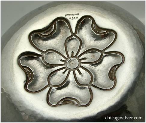 Kalo bowl, early, round, with chased and repoussé figure of overlapping blossoms in flat, slightly domed bottom -- bottom view