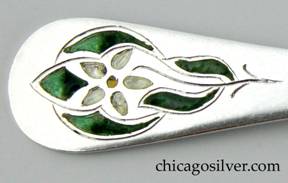 Detail from small enameled Margaret Rogers fork, with two slender pointed tines that curve outward at the ends, tapered handle with wide round end that has chased flower, stem, and leaves with green, yellow, and white enamel.