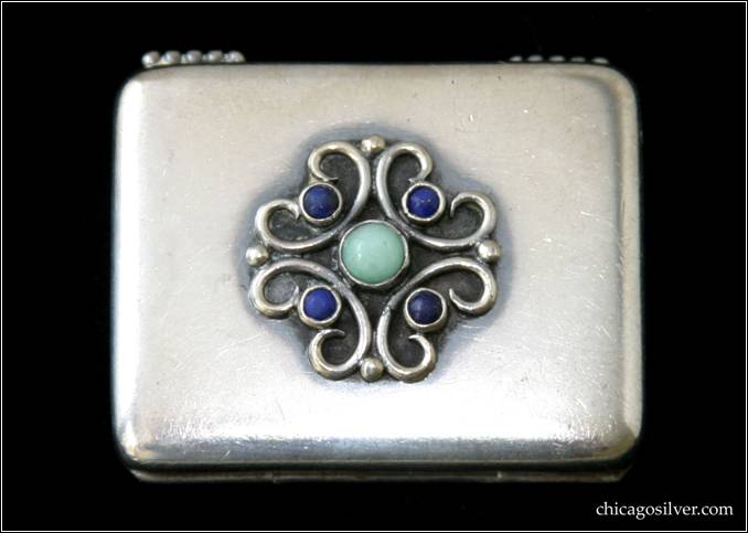 Kalo pillbox, hinged with applied wire work and bezel-set stones (four lapis lazuli beads and one round, turquoise cabochon).  Gold wash interior.  Heavy.  1-3/4" L and 1-3/8" W.  Marked HAND / WROUGHT / STERLING / KALO