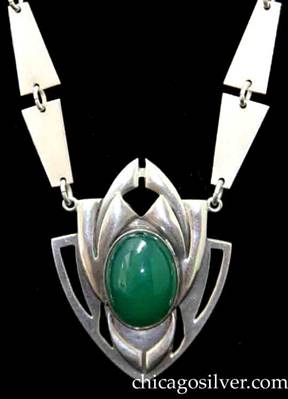 Art Silver Shop necklace, composed of 20 hammered trapezoidal links connected by small loops, centering a pendant with a large green oval stone.  The links are arranged in pairs with the wide ends together.  The pendant is shield-shaped with pierced geometric details extending from the curved sides and at the top, and applied curving cutout forms centering a large oval green bezel-set cabochon stone.
