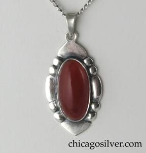 Art Silver Shop pendant on chain, oval, with repouss sides, triangular bezel, and oval bezel-set cabochon carnelian stone with open back.  On delicate replacement chain.