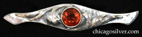 Art Silver Shop brooch / pin, long, with rounded center tapering away from the middle then flaring out again at the ends, which are curved and pointed.  Large round bezel-set orange faceted topaz stone at center flanked on both sides with chased and applied leaves.  Hammered surfaces.