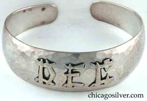 Art Metal Studios bracelet, with open back and tapering rounded ends, applied "DEC" mono in oriental style, nice hammering.