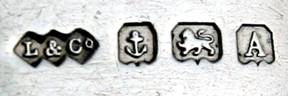 British marks, like this from Liberty & Co., indicate the maker, the city assay office (anchor means Birmingham), quality (lion rampant means sterling) and date (A is 1925)
