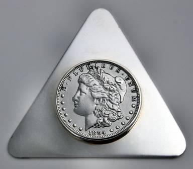 90% silver coins are sometimes used in sterling items -- this paperweight by Leonore Doskow is a good example.

