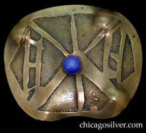 Pin, brass, large, freeform oval shaped, with acid-etched oriental-style geometric design centering bezel-set blue stone.  Four repousse bulges at the corners.