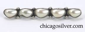 Unsigned brooch / pin, composed of five irregular bezel-set baroque pearls in a row each with two silver beads between them.