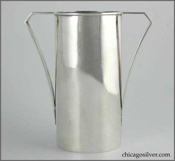 Kalo vase, cylindrical, with flat strap handle that creates a horizontal plane with the rim, then angles down and gracefully curves to meet the body.  Applied wire to rim.  Simple but classic, elegant form.  In excellent shape.  6-1/4" H and 5-7/8" W.  Marked:  STERLING / HAND BEATEN / AT / KALO SHOPS / PARK RIDGE ILLS.  / 9544